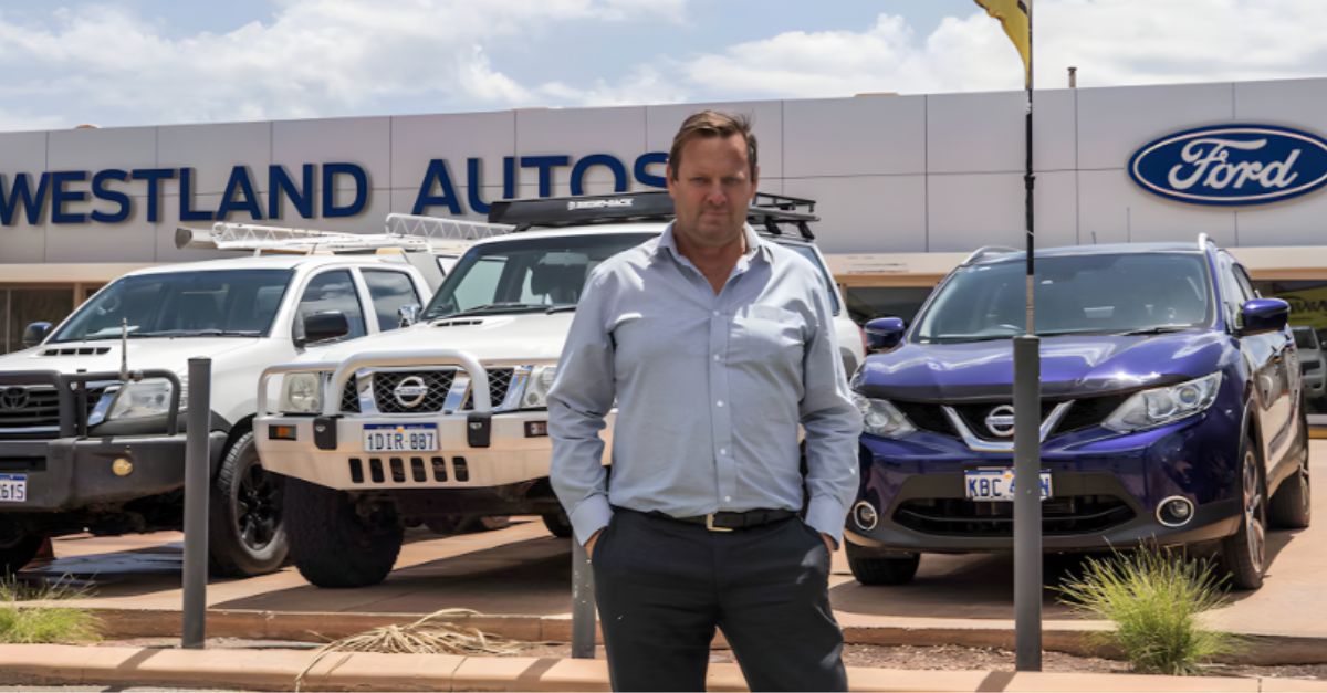 Man standing in front of a Ford Dealership