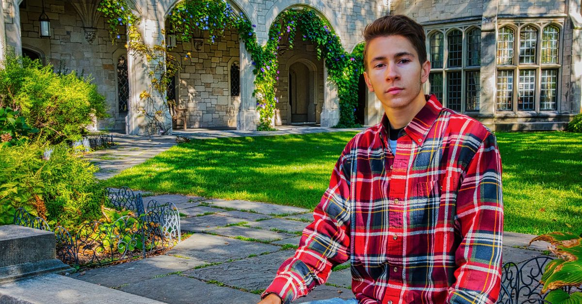 Boy standing infront of his house