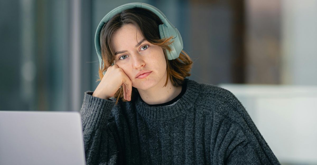 Young Adult Using Laptop look stressed