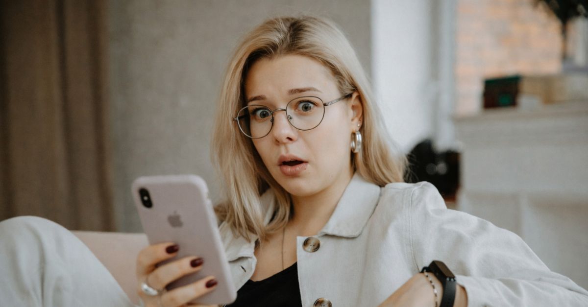 Surprised woman holding a smartphone