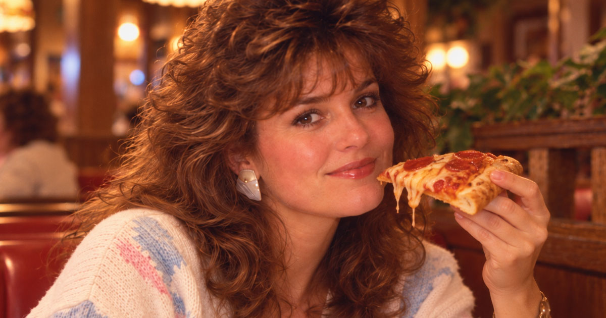 1980s woman eating pizza