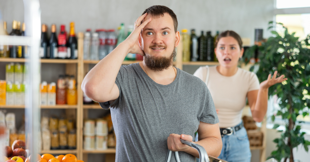 Married couple argues in a store while choosing products. Husband and wife quarrel in a supermarket.