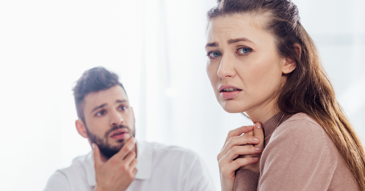 panoramic shot of worried woman looking at camera during group therapy session