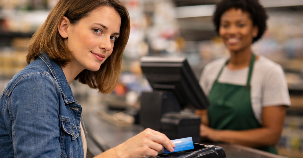 Woman tap card to pay at store