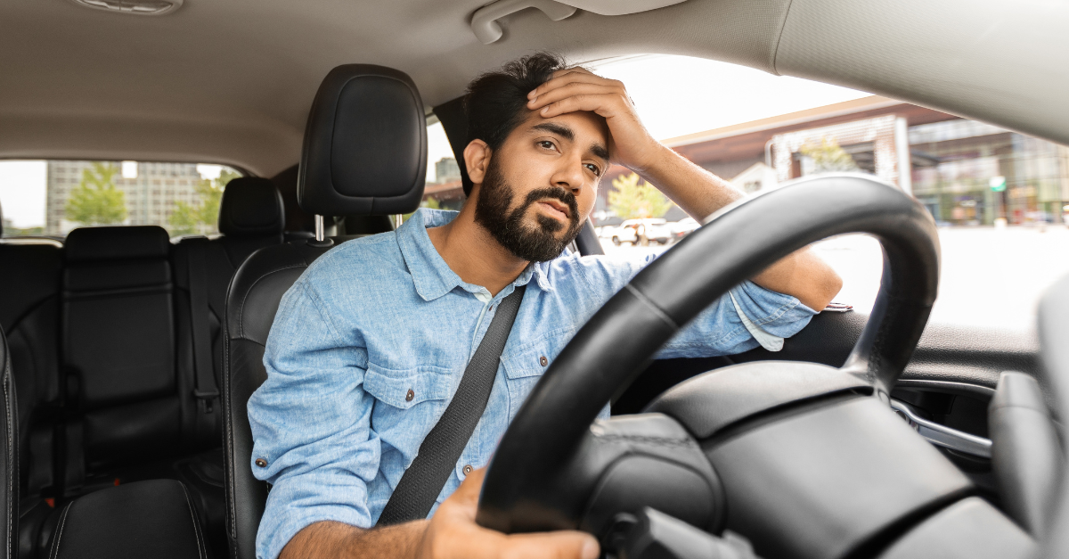 Guy driving car despair after accident.