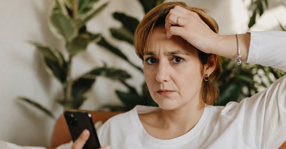 Worried woman using a phone