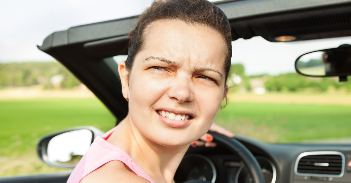 Young Woman Looking Back While Travelling In Car