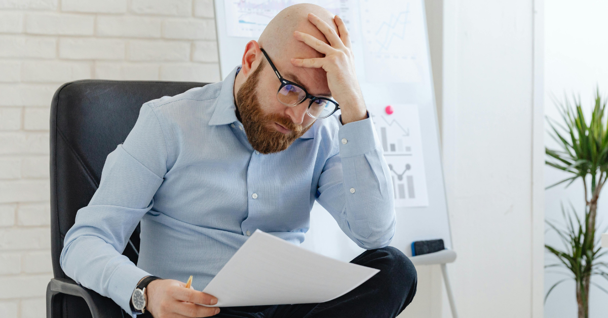 a-disappointed-man-looking-at-a-paper