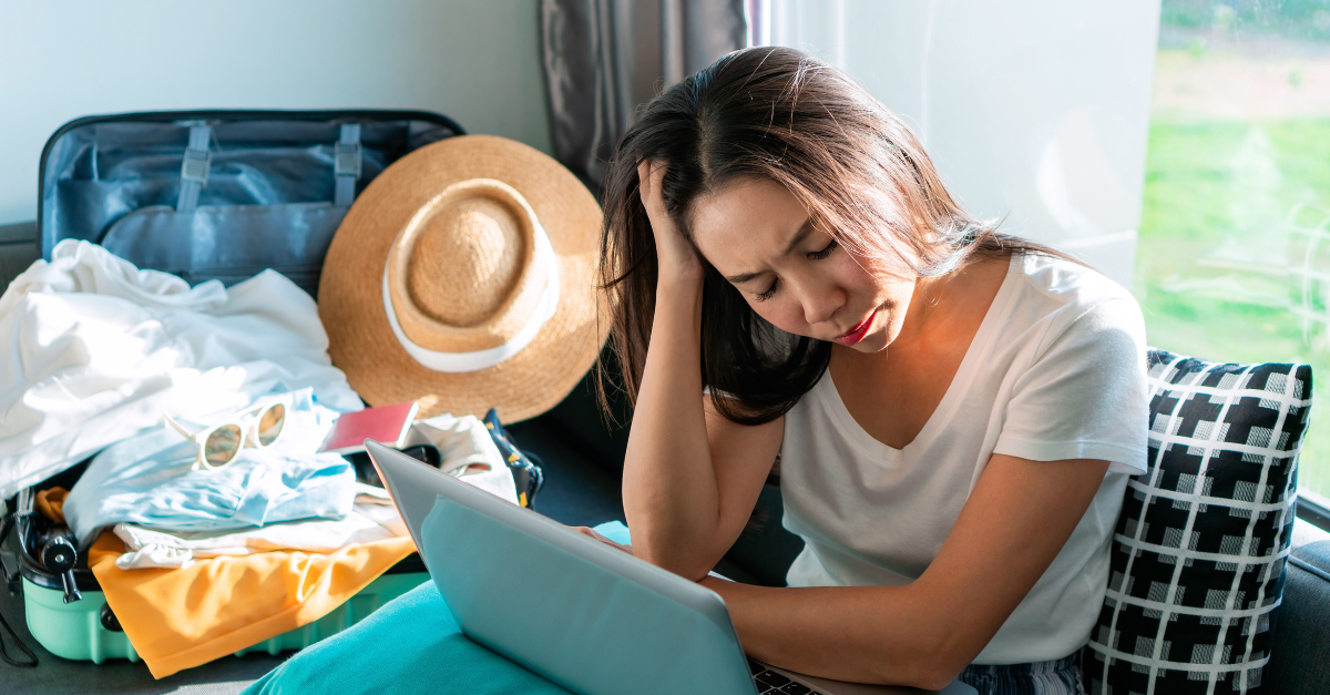 Asian woman is stressed while planning a trip.