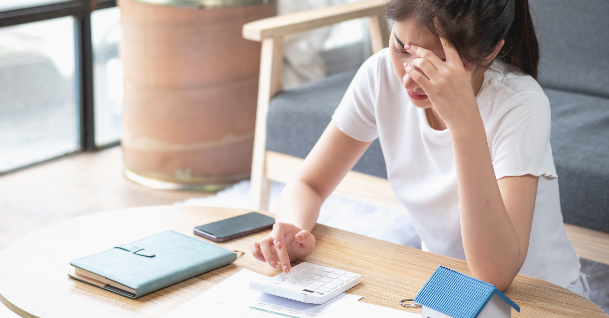 Young Asian woman sitting and calculating expenses
