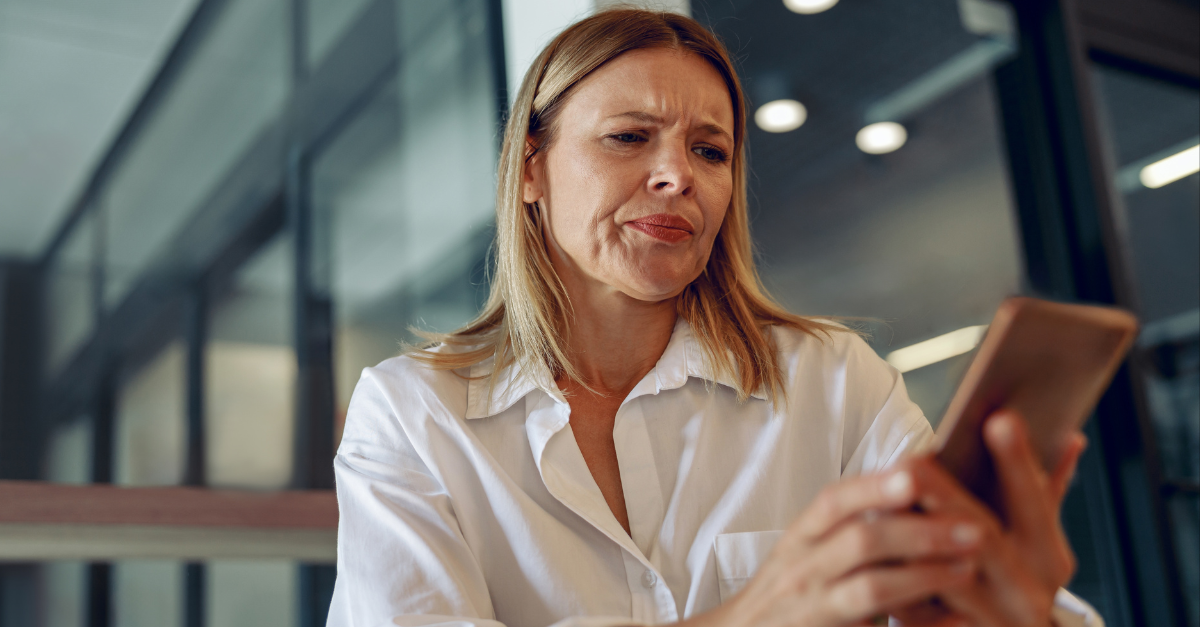 Worried woman manager holding phone