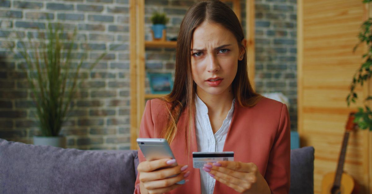 Confused Woman With Phone And Card