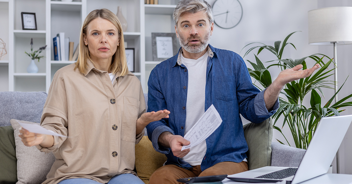 Confused Mature Couple On A Sofa