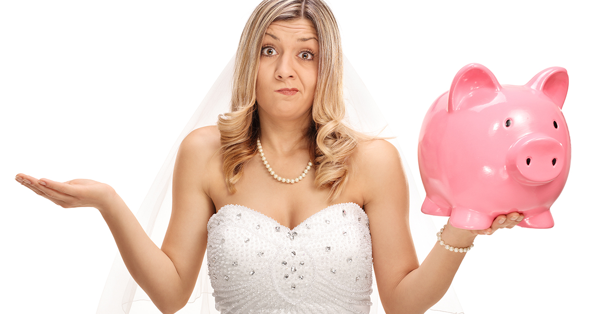 Blonde bride holding a pink piggy bank.