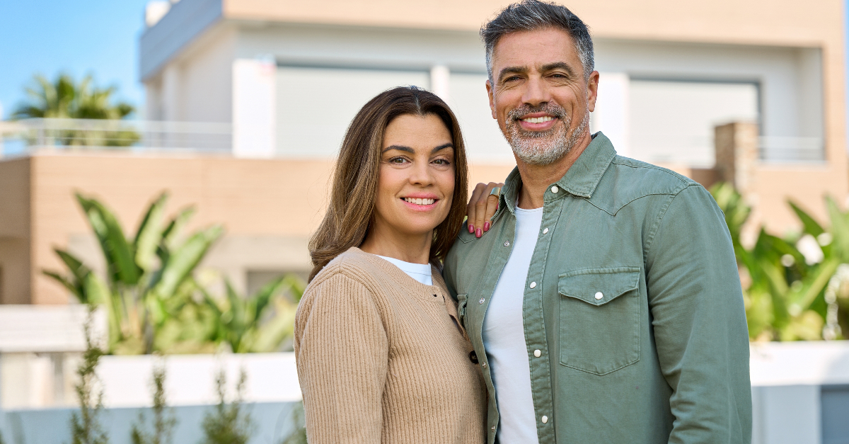 Happy smiling mature older family couple new property buyers