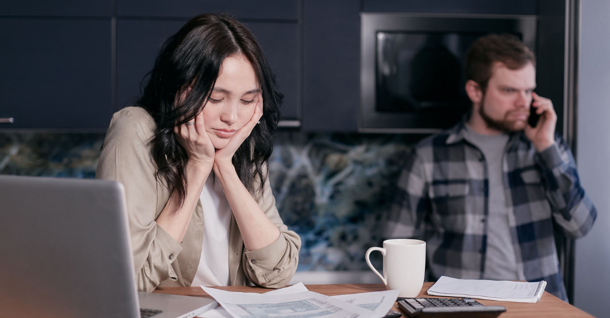 a-woman-looking-at-a-document-resting-her-chin-on-her-hands