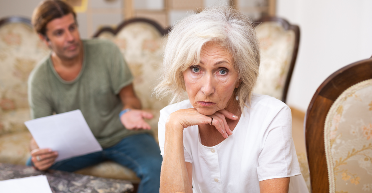 elderly woman worried about finances, man in background explaining them to her
