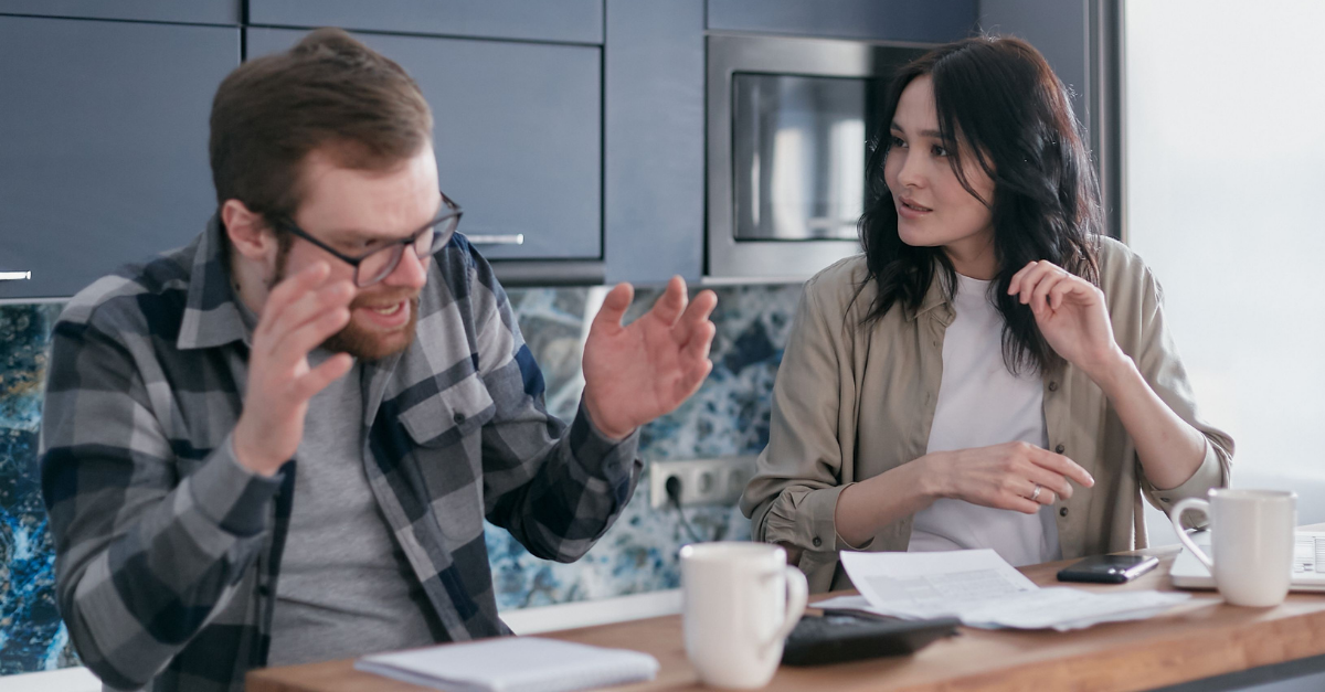 anxious-man-talking-to-a-woman-sitting-beside-him
