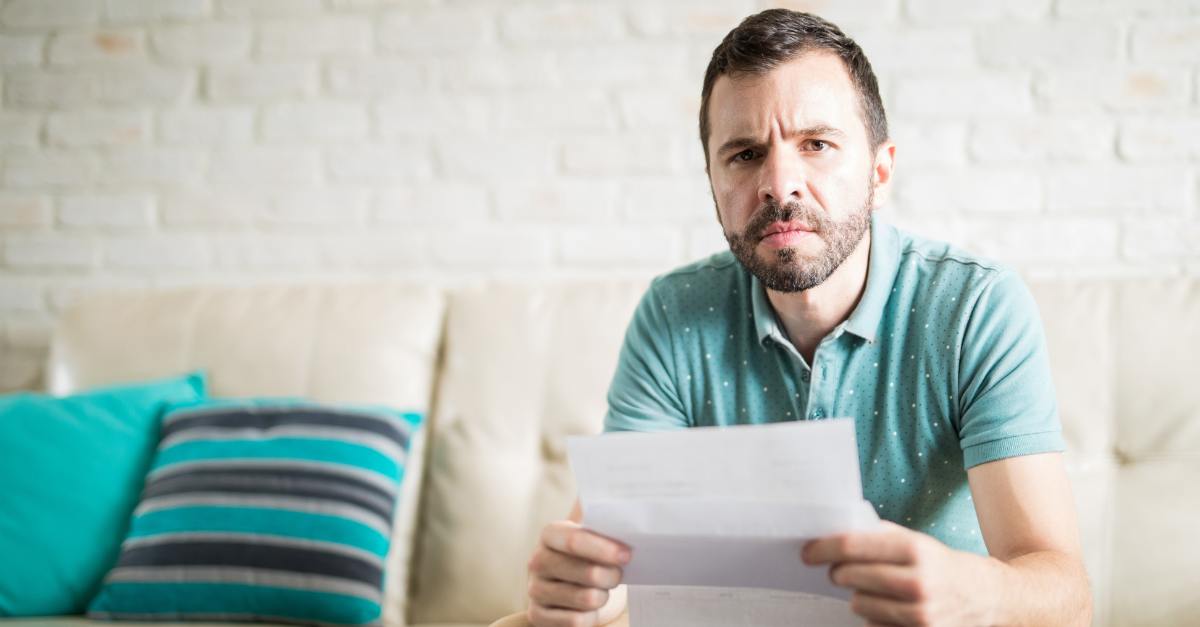 hispanic-man-reading-some-bad-news