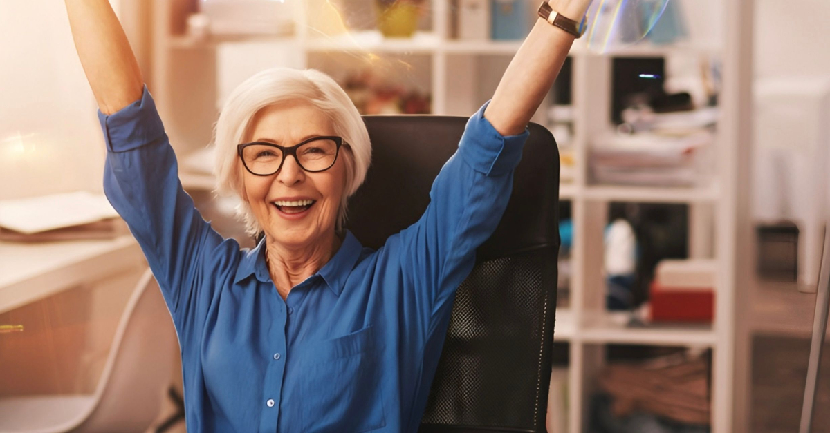 Baby Boomer woman cheering at her workplace