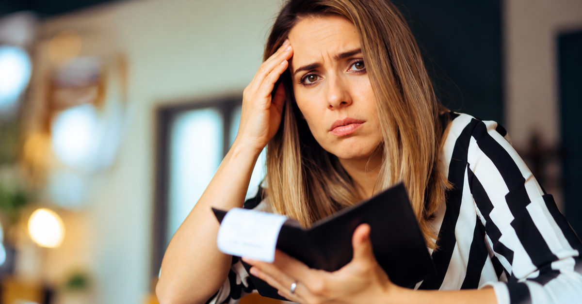AI-generated image of a worried woman holding a bill