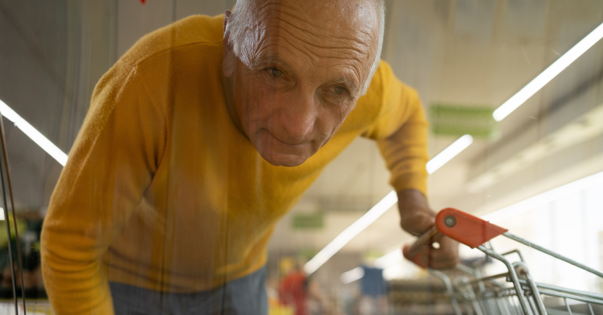 Elderly man shopping in a supermarket