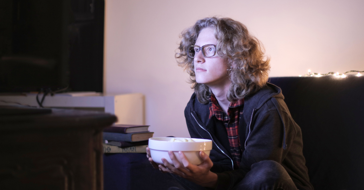 man-with-a-bowl-of-popcorn-watching-tv