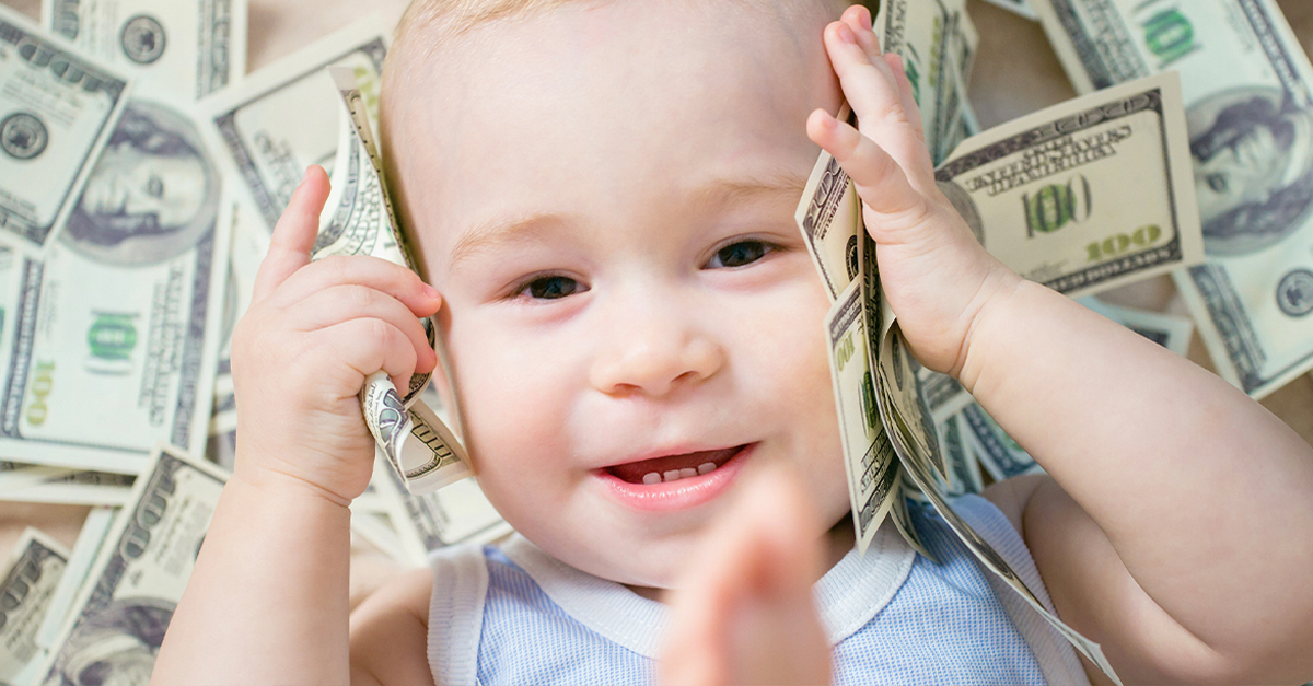 Cute hapy baby boy playing with a lot of money, american hundred dollars cash